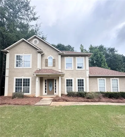 A classic two-story residence with a welcoming entry and neatly maintained front landscaping.
