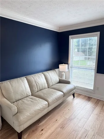 Richly colored walls complement durable hardwood flooring in this versatile living space.