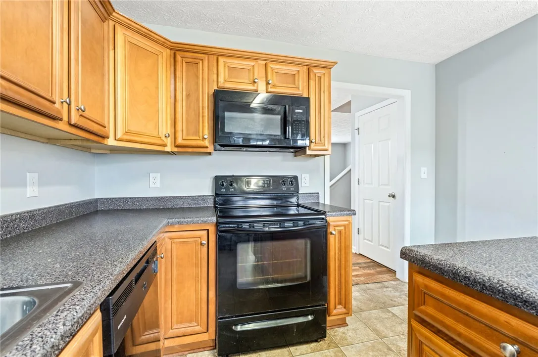 Well-appointed kitchen featuring ample cabinetry, practical countertops, and essential appliances for daily living.
