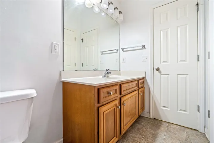 A classic bathroom vanity with a spacious mirror provides ample counter space and storage.