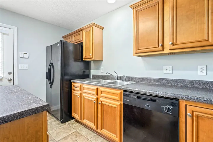 Functional kitchen with ample cabinet space and durable countertops, ready for everyday meals.