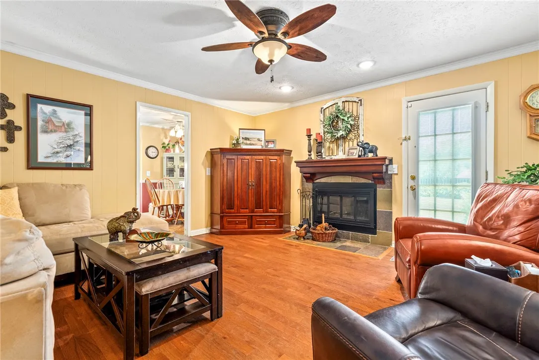 A welcoming living room featuring laminate hardwood floors and a cozy fireplace, perfect for gatherings.