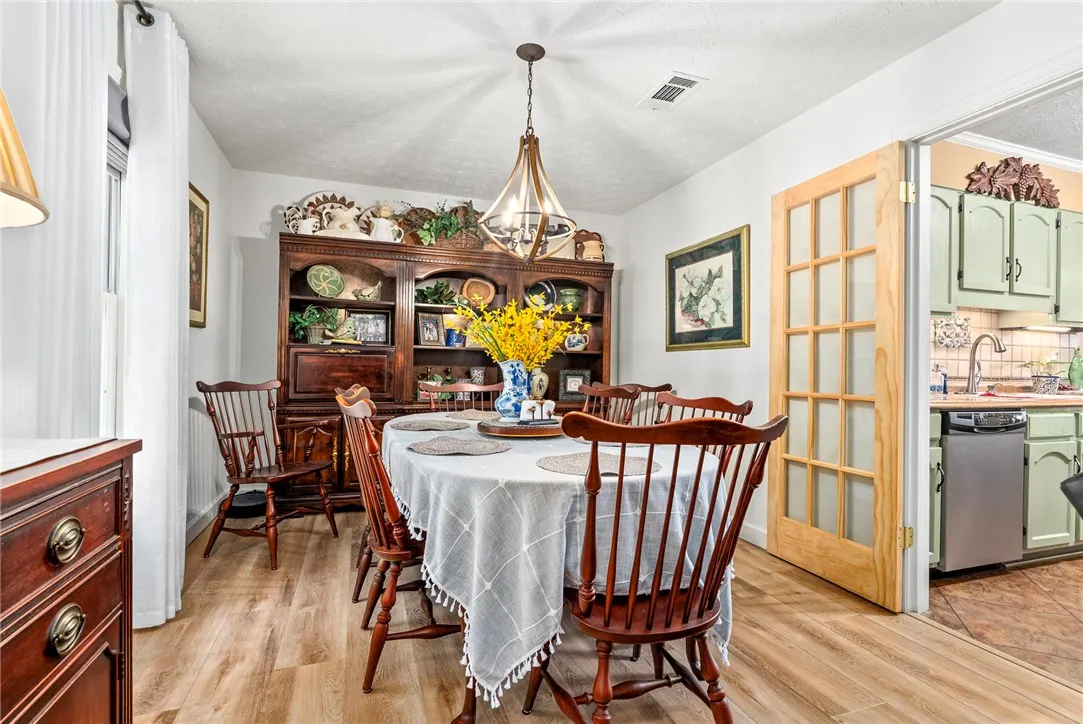 LVP flooring extends throughout this dining area, providing a seamless flow to the adjacent kitchen.