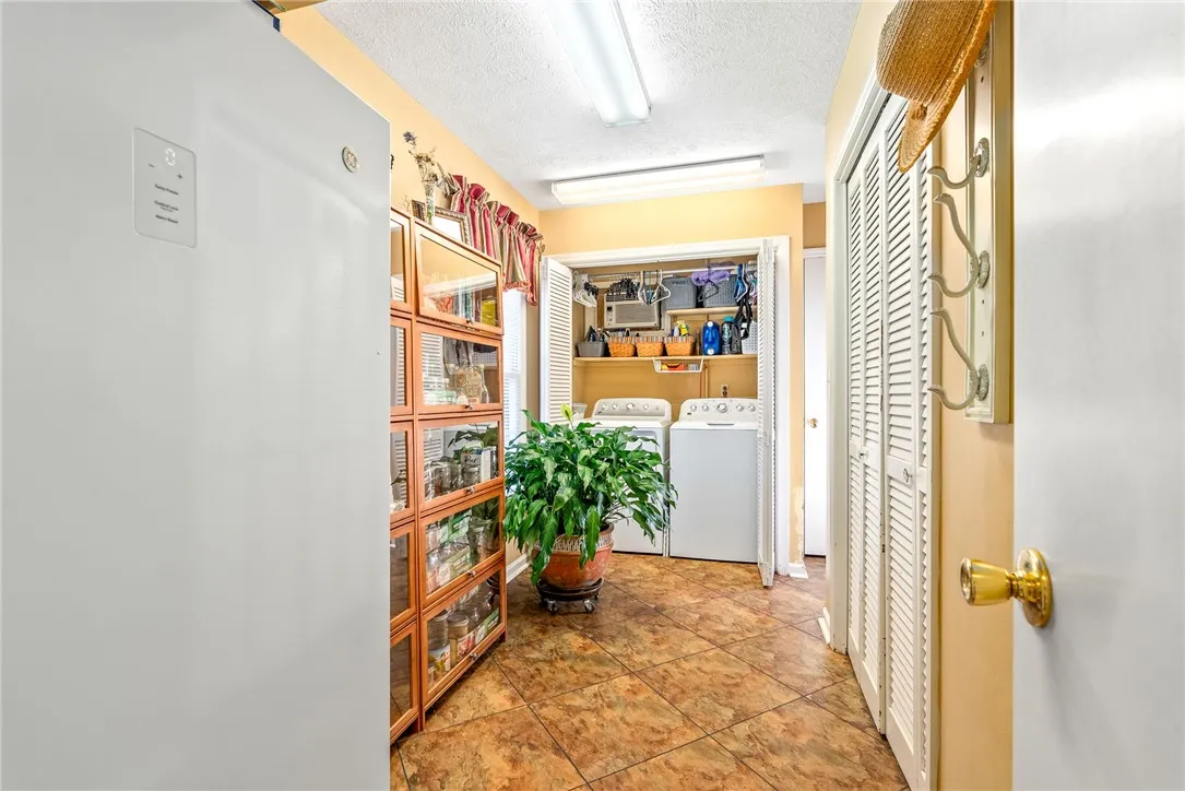 Functional laundry space with easy access to appliances and a built-in storage pantry.