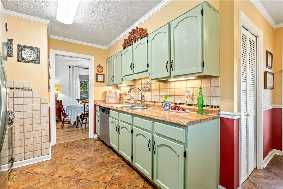 A well-equipped kitchen features a stainless steel dishwasher and ample cabinet space.