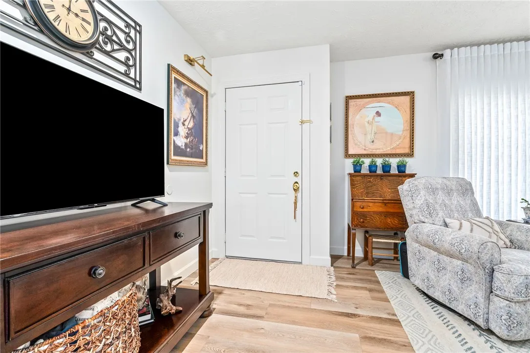 A welcoming entryway with rich LVP flooring leads into this comfortable living space.