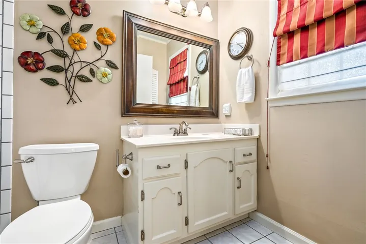 A bright bathroom with a classic vanity.