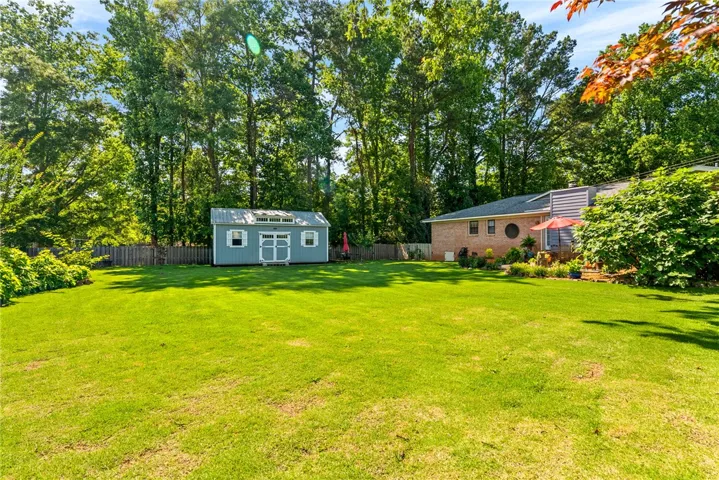 A spacious, well-maintained backyard with a charming shed and ample room for recreation.