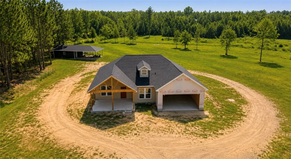A newly constructed residence nestled amidst expansive, verdant grounds and mature woodlands.