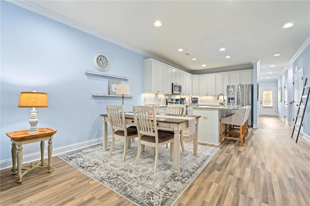 An inviting eat-in kitchen with bright cabinetry and a spacious island flows seamlessly into the dining area.