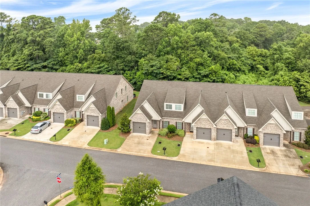 Rows of well-maintained townhomes offer appealing curb appeal with lush green landscaping.