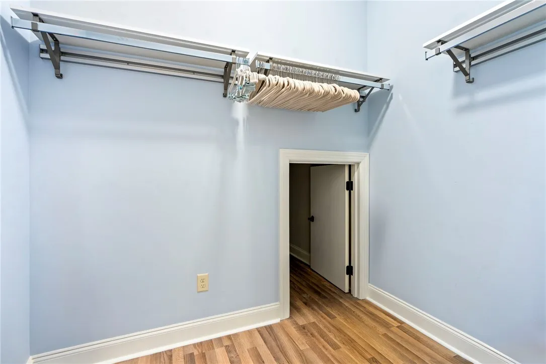 Ample hanging space with extra storage in the back for the primary bedroom closet.