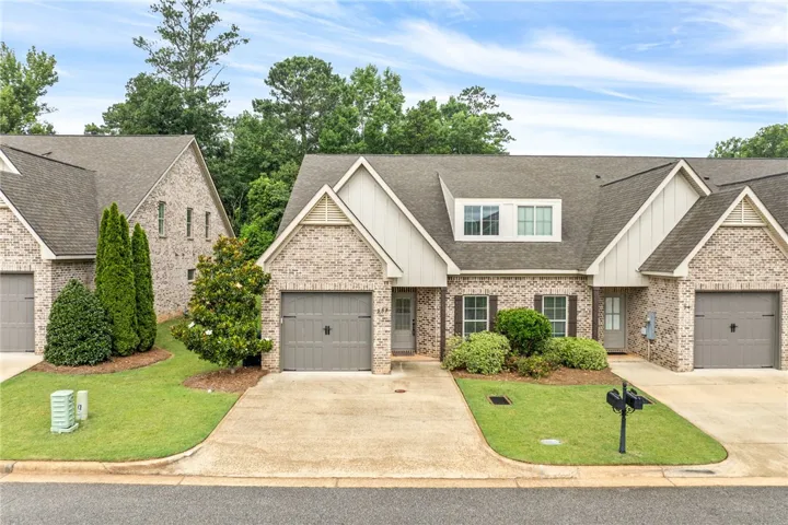 A classic brick exterior with well-maintained landscaping and a welcoming front entrance.