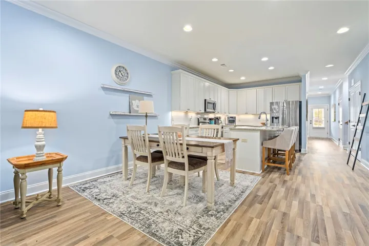An inviting eat-in kitchen with bright cabinetry and a spacious island flows seamlessly into the dining area.