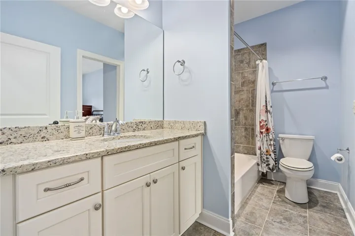 Granite counters and tiled shower enclosure adorn this well-appointed bathroom. Can be accessed from the second bedroom or hallway.