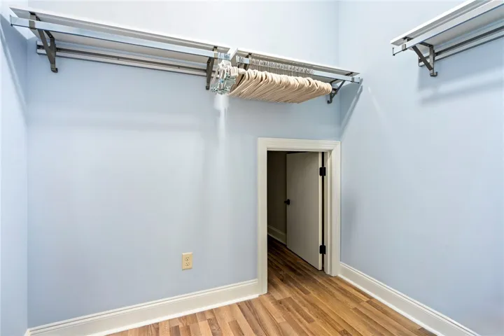 Ample hanging space with extra storage in the back for the primary bedroom closet.