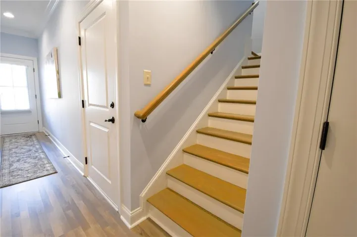 Staircase off the foyer to bonus/bedroom 3 and bath
