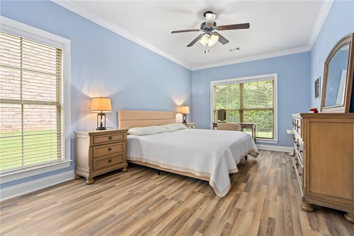 Large primary bedroom on the main level boasts plenty of windows and a large en suite bathroom