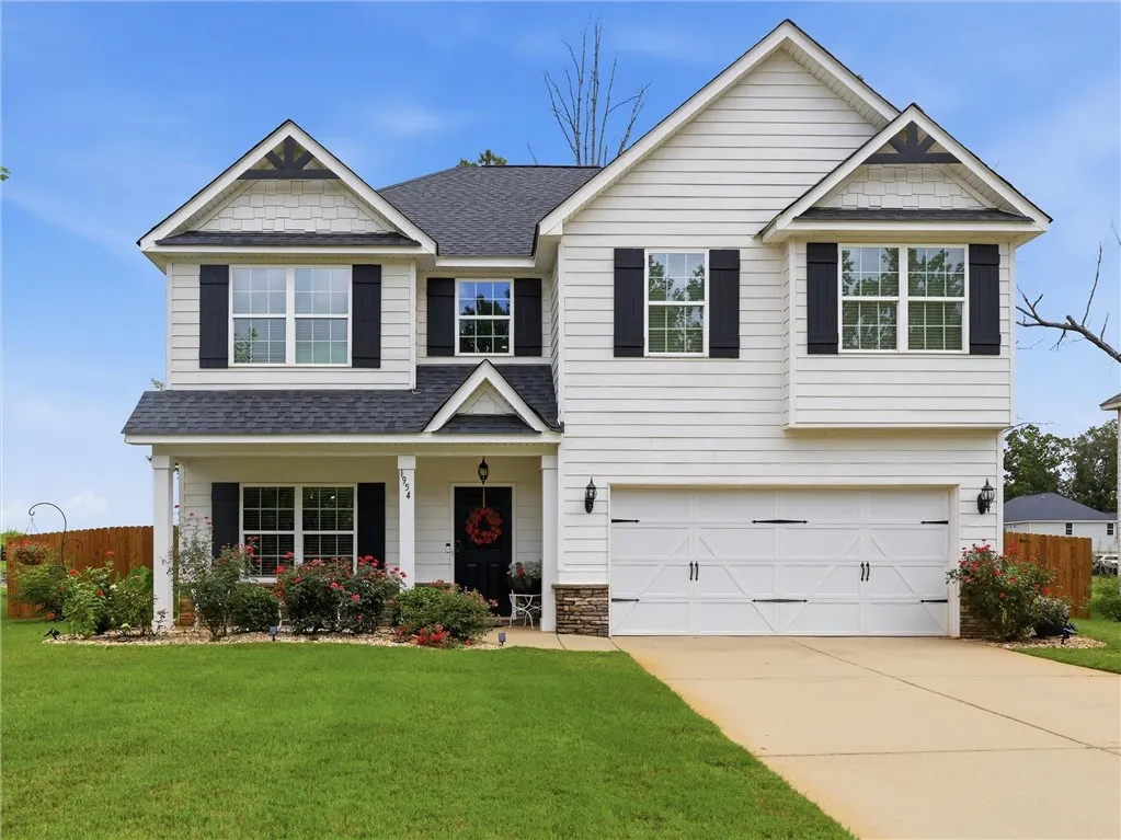 A classic facade with charming white siding and dark shutters welcomes you home.