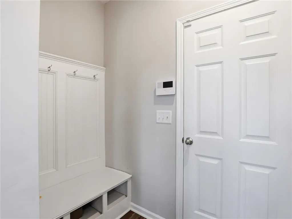 A convenient built-in bench and coat rack create an organized entry.