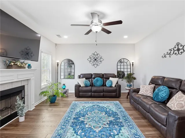Hardwood floors and recessed lighting elevate this inviting living space.