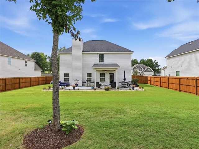 A spacious backyard with a private patio offers ample room for outdoor enjoyment and entertaining.