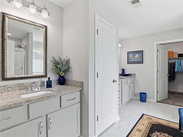 A well-appointed bathroom vanity with granite counters, offering both style and practical storage solutions.