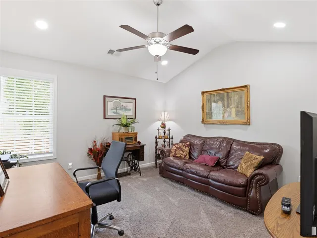 A versatile home office offers a comfortable seating area, perfect for work or relaxation.