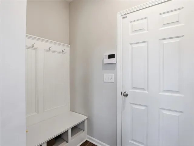 A convenient built-in bench and coat rack create an organized entry.