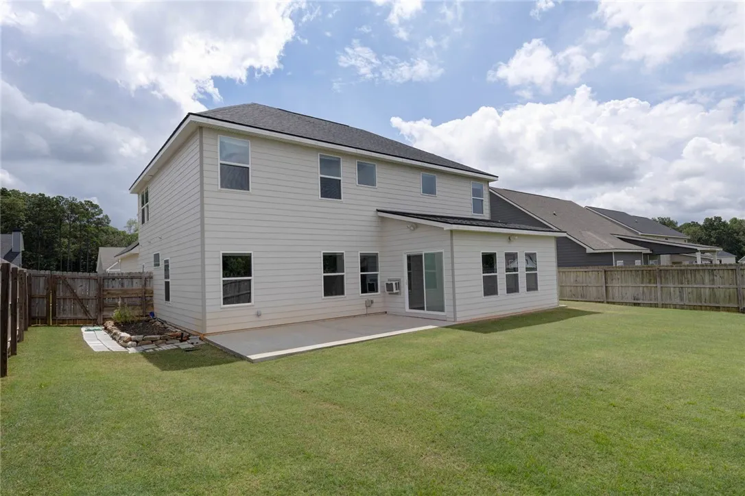 A spacious backyard with a concrete patio awaits outdoor entertaining.