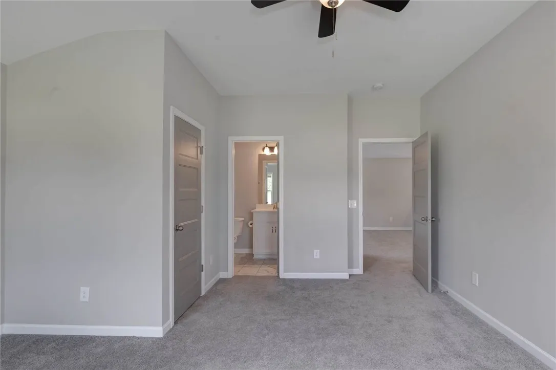 An inviting room features plush carpeting and a convenient en-suite bathroom access.