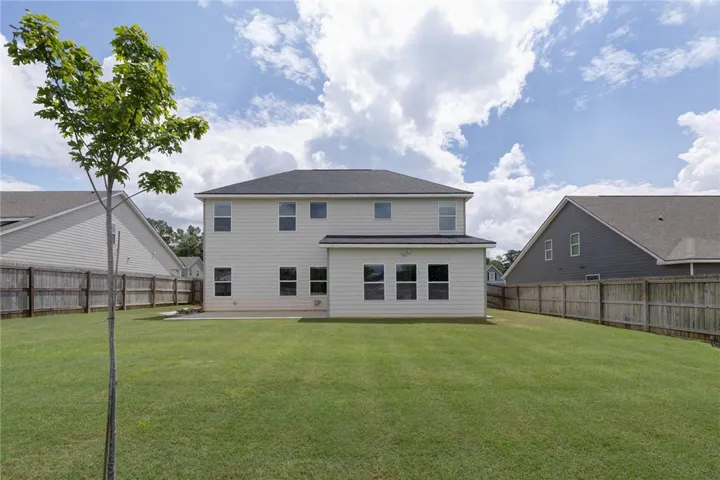 A spacious backyard awaits, fully fenced for privacy and outdoor enjoyment.