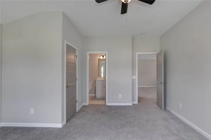 An inviting room features plush carpeting and a convenient en-suite bathroom access.