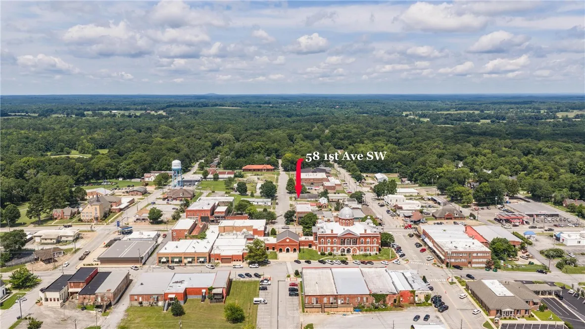 An aerial perspective reveals a charming town nestled amidst expansive green landscapes.
