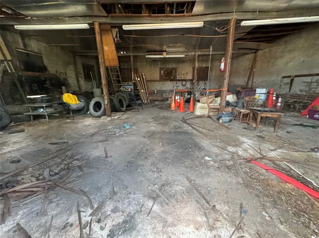 A spacious, unrestored warehouse interior presents a blank canvas for renovation.
