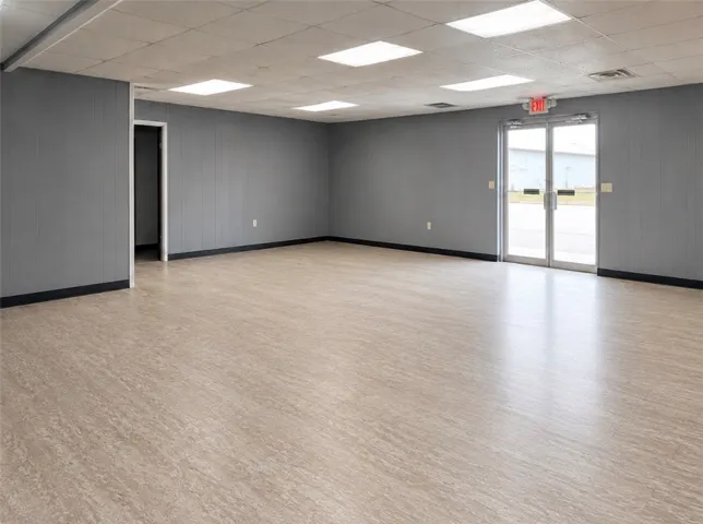A versatile open-plan space with durable vinyl flooring, ready for various commercial ventures.