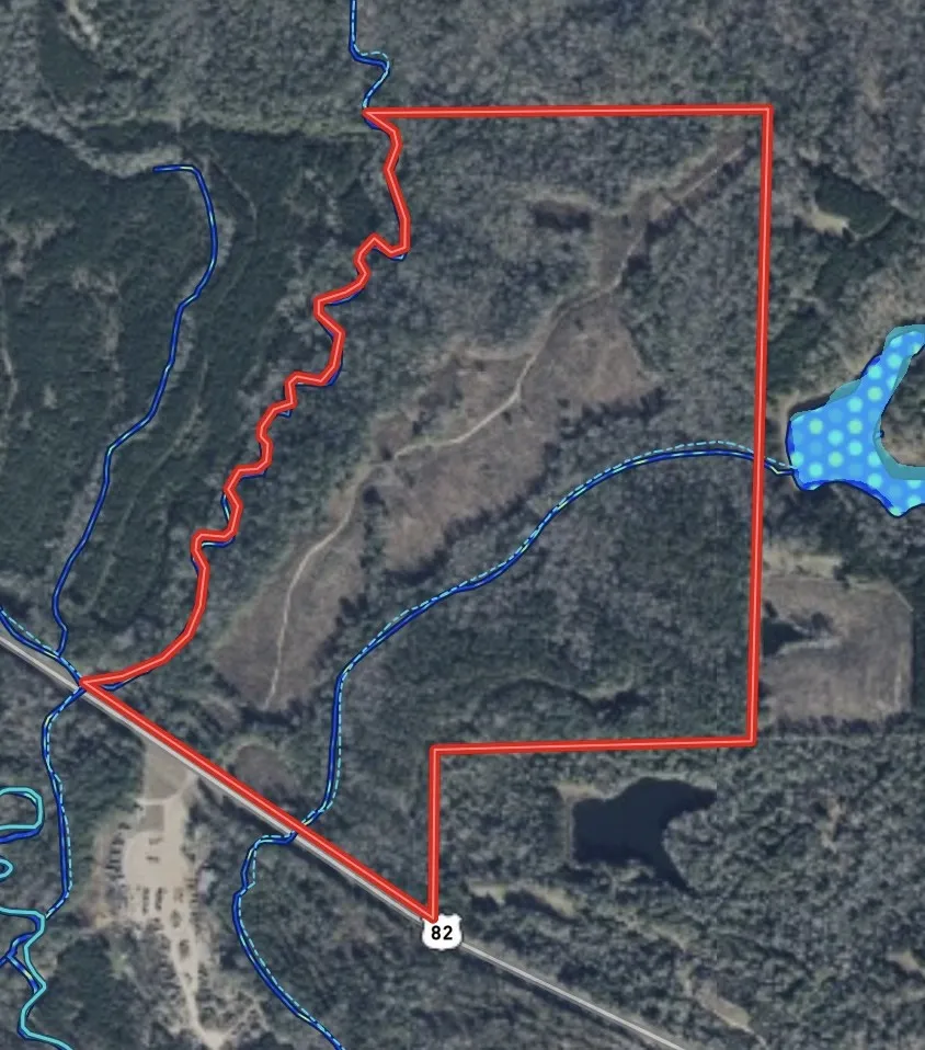 A sprawling tract of wooded land offers diverse topography and a serene natural setting.