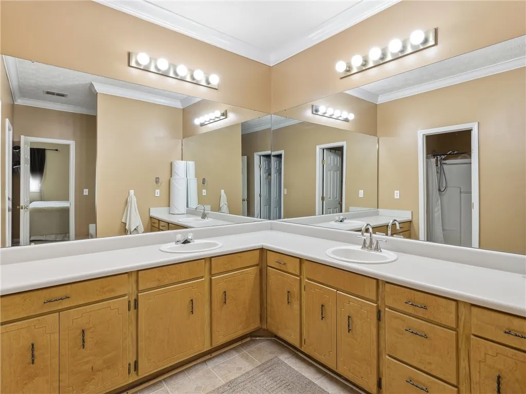 Double vanities with ample storage enhance this spacious bathroom's practicality.