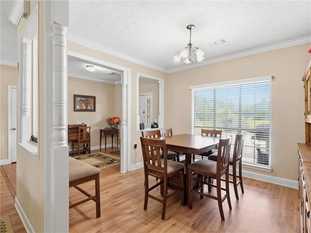 Hardwood floors and generous natural light define this inviting dining area.