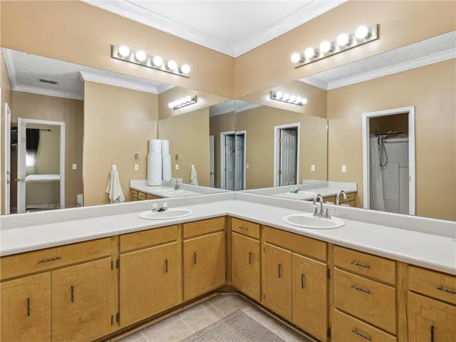 Double vanities with ample storage enhance this spacious bathroom's practicality.