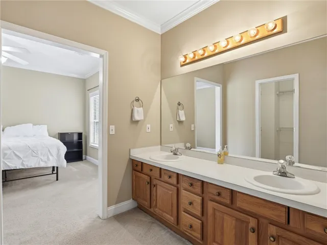 Double vanity with ample storage and bright lighting provides practical elegance in this bathroom.