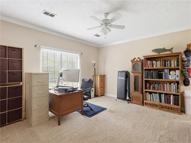 A well-lit bonus room offers versatility as a home office or creative space, complete with carpeted flooring.