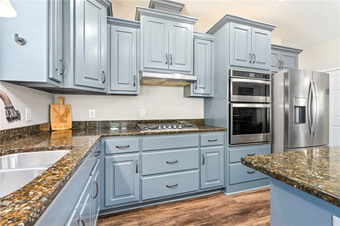 Granite counters and stainless steel appliances elevate this contemporary kitchen design.