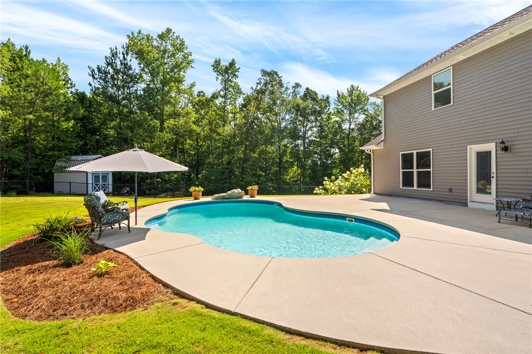A private swimming pool and expansive patio area beckon for outdoor enjoyment.