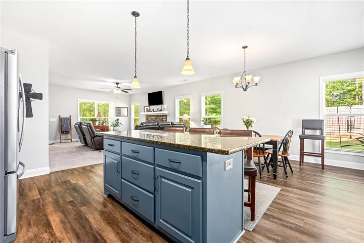 An open floorplan seamlessly connects the well-appointed kitchen island to the inviting living area.