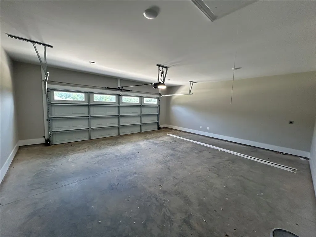 A spacious, newly finished garage provides ample room for vehicles and storage.