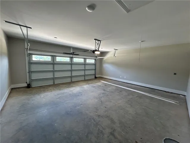 A spacious, newly finished garage provides ample room for vehicles and storage.