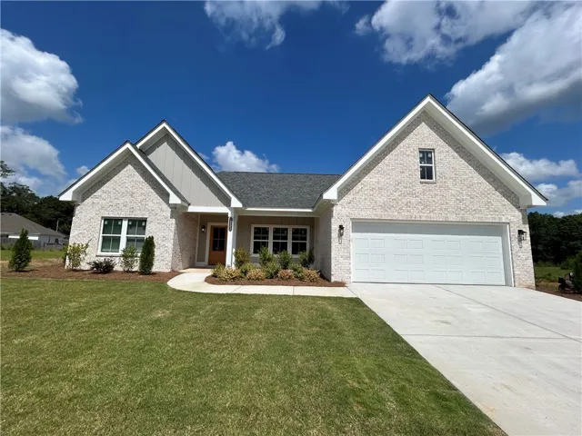 A newly constructed residence showcasing a clean facade and inviting entryway, perfect for modern living.