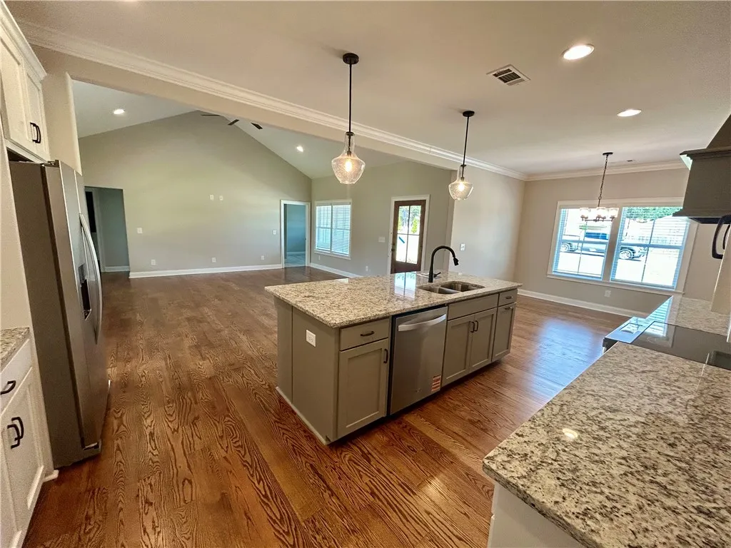 An open-concept living space integrates a well-appointed kitchen island with ample countertop space, perfect for entertaining.