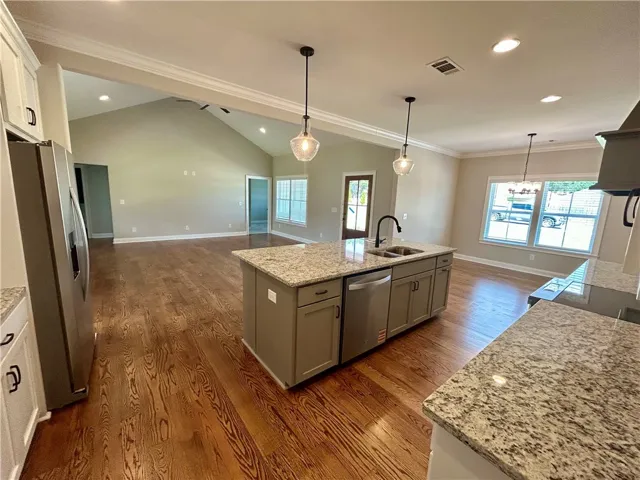 An open-concept living space integrates a well-appointed kitchen island with ample countertop space, perfect for entertaining.